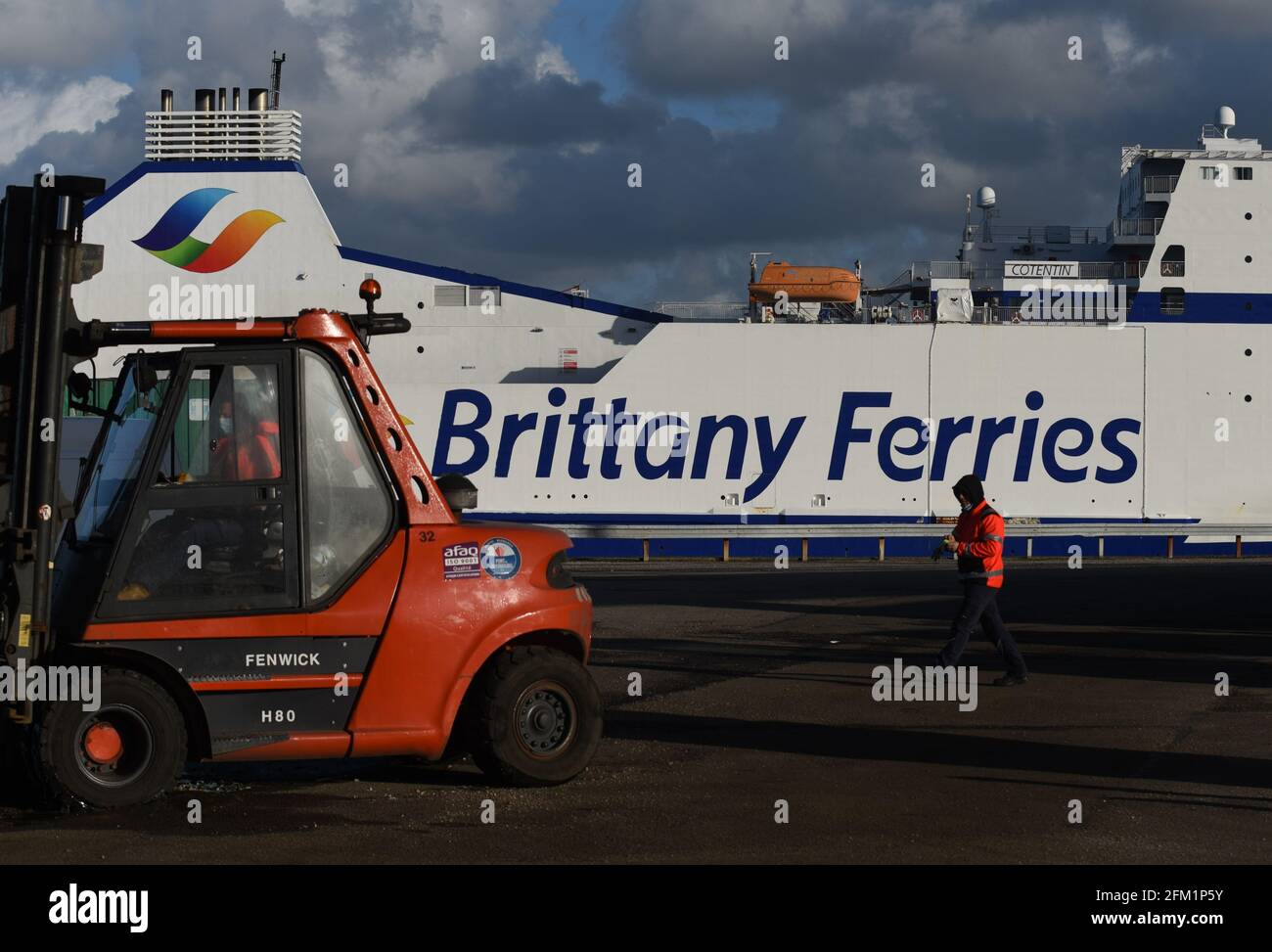 *** STRICTLY NO SALES TO FRENCH MEDIA OR PUBLISHERS - RIGHTS RESERVED ***February 18, 2021 - Cherbourg, France: French dockers prepare to unload a freight ferry from Ireland at the Cherbourg harbour. Officials at the Normandy port of Cherbourg reported that their business tripled since Brexit led to a surge in direct traffic between the European Union and the island of Ireland. Freight ferries take 17 hours to cross the sea between France and Ireland. Stock Photo