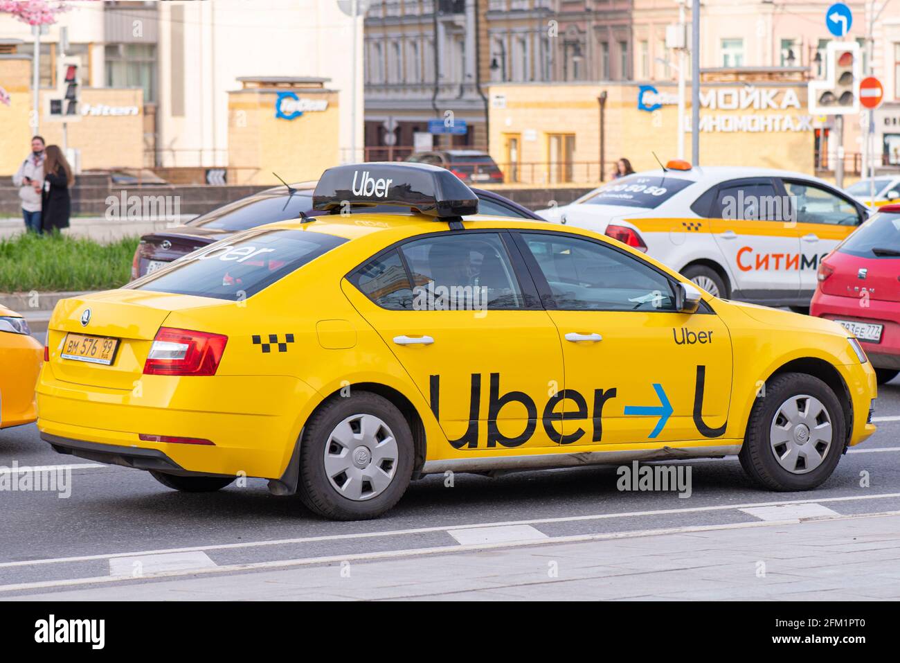 MOSCOW - MAY 02: Yellow taxi car with UBER logotype in a street of Moscow, May 02. 2021 in Russia. Stock Photo