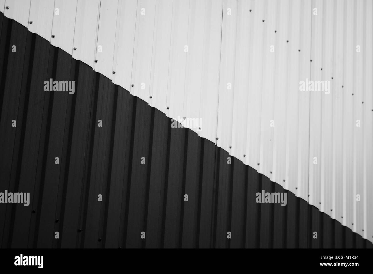 Black and white corrugated iron sheet used as a facade of a warehouse