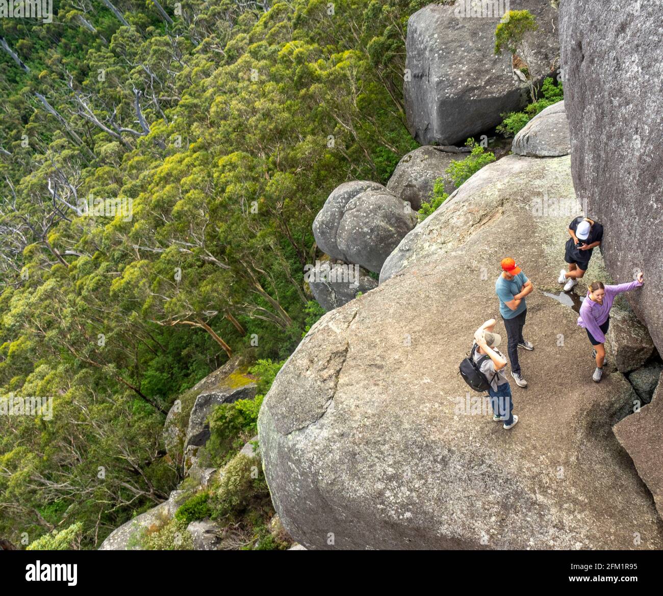 Tourists hiking Castle Rock Walk Trail in the Porongurup National Park near Albany Western Australia. Stock Photo