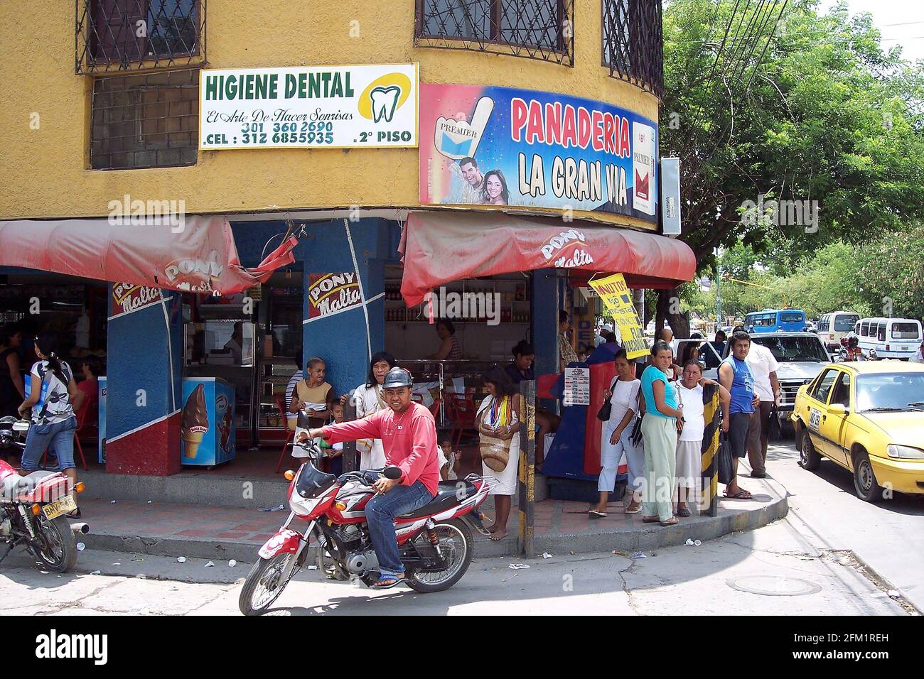 Street scene, shoppers, man on motorbike, Santa Marta, Columbia Stock