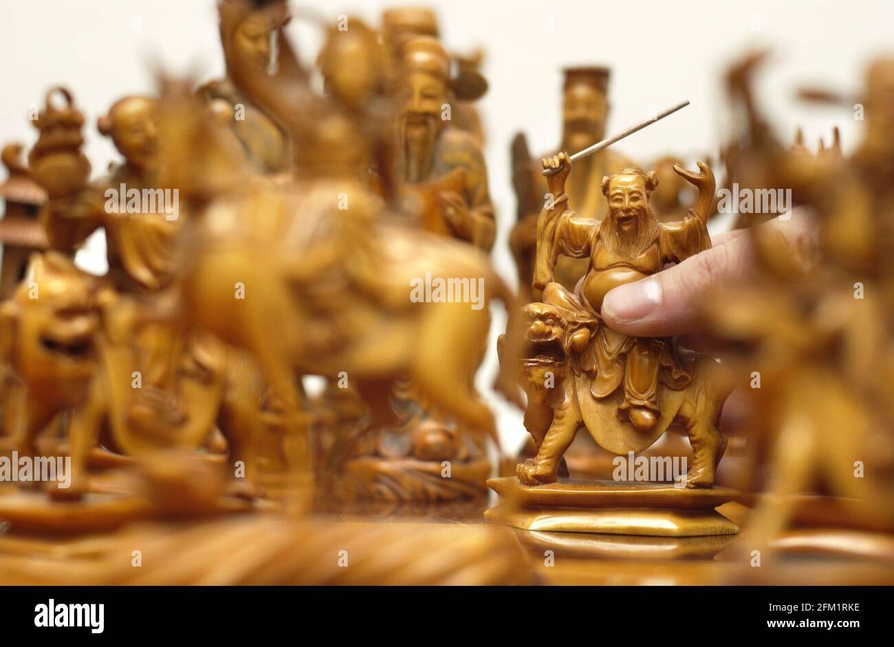 A fine chinese IVORY figural set of large size chess figures representing Chinese deities, one tea stained the other left natural, up for auction on Monday 4 November by Cooper Owen auctioneers. The set is est  3-5,000.28 October 2002 photo Andy Paradise Stock Photo