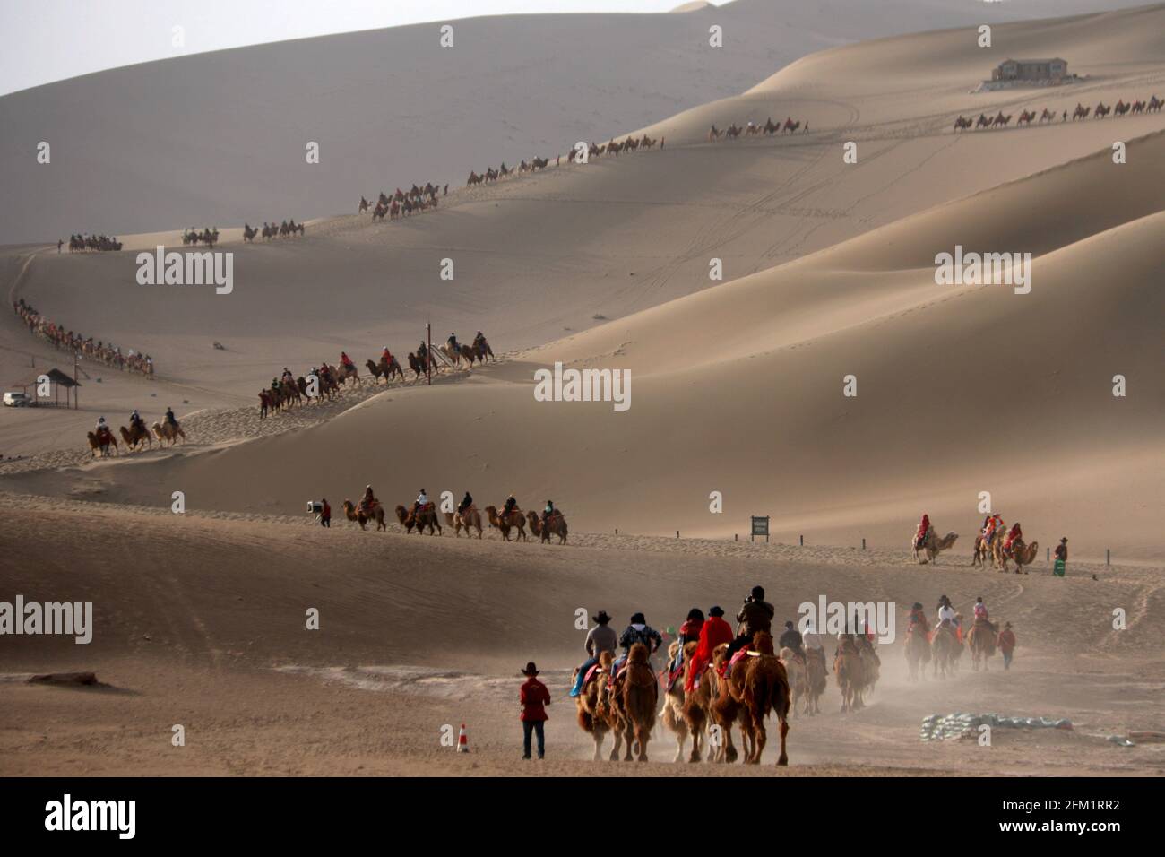 Beijing, China's Gansu Province. 1st May, 2021. Tourists visit Yueya Spring, a crescent-shaped lake in Dunhuang City, northwest China's Gansu Province, May 1, 2021. Official data showed 230 million domestic tourist trips were made during the five-day Labor Day holiday, up 119.7 percent from last year. Credit: Zhang Xiaoliang/Xinhua/Alamy Live News Stock Photo