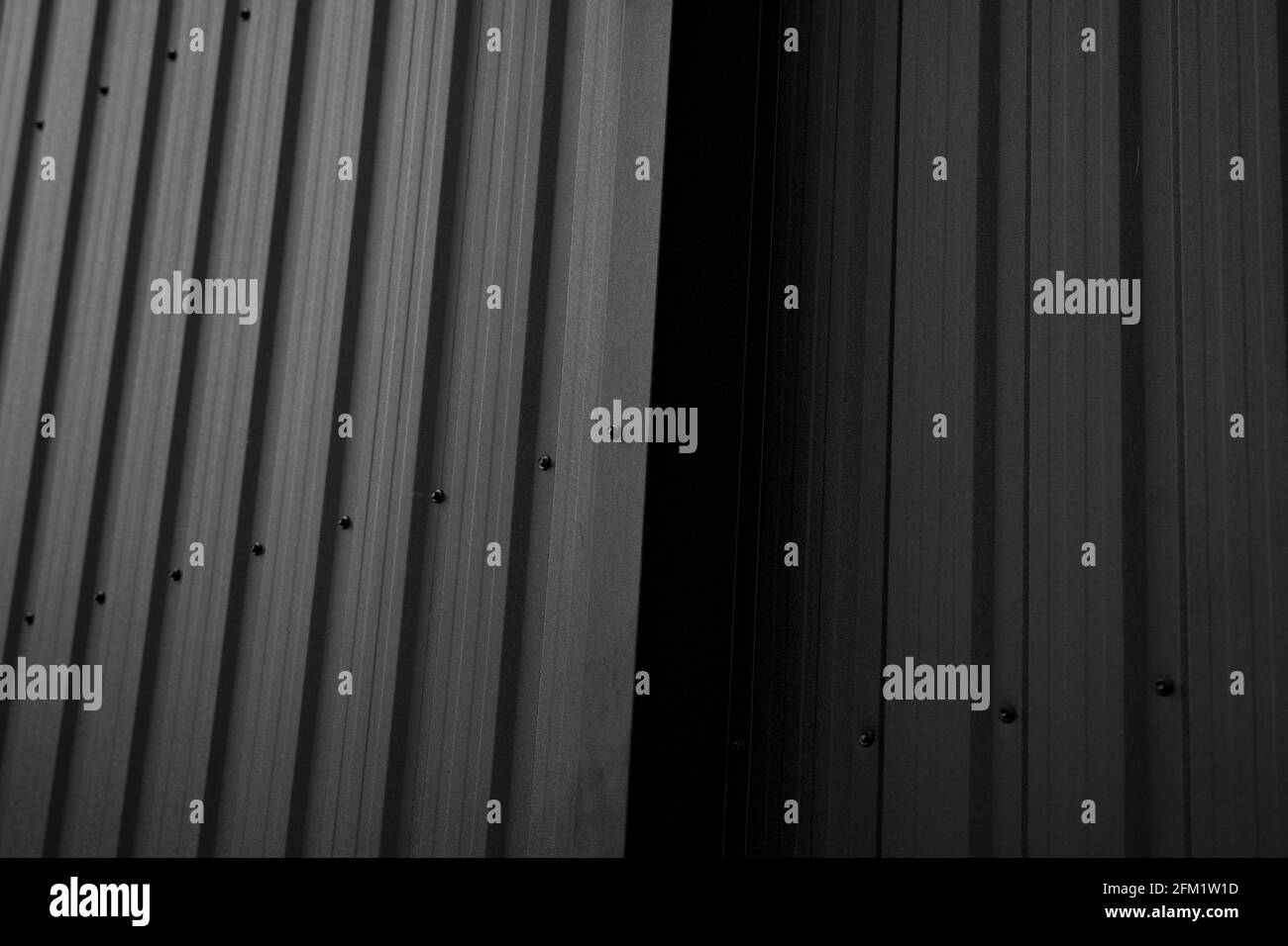 Black corrugated iron sheet used as a facade of a warehouse or factory