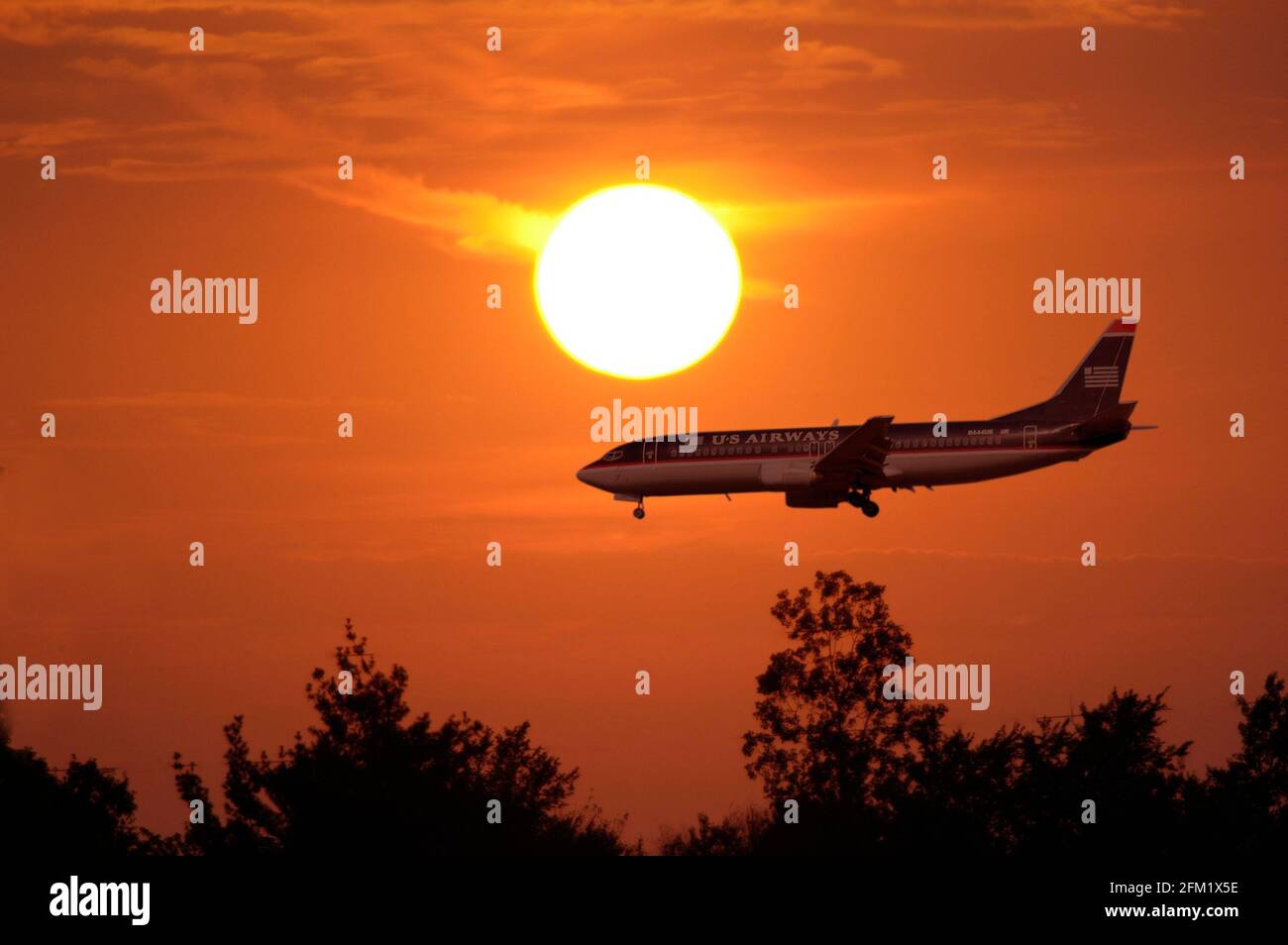 Silhouette of air plane as it prepares to land Stock Photo