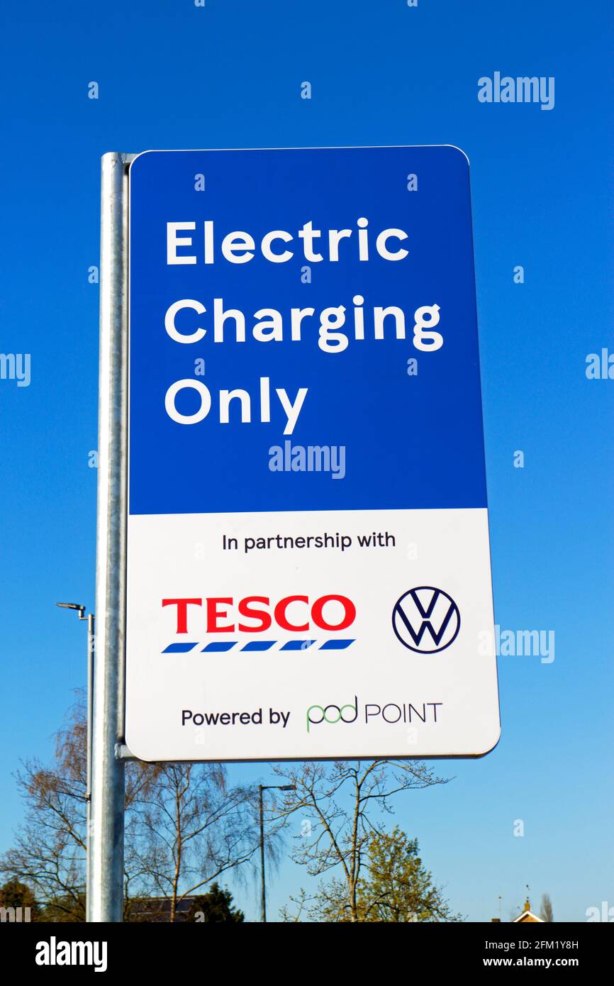 A sign indicating position of an electric vehicle recharging point on a supermarket car park at Sprowston, Norfolk, England, United Kingdom. Stock Photo
