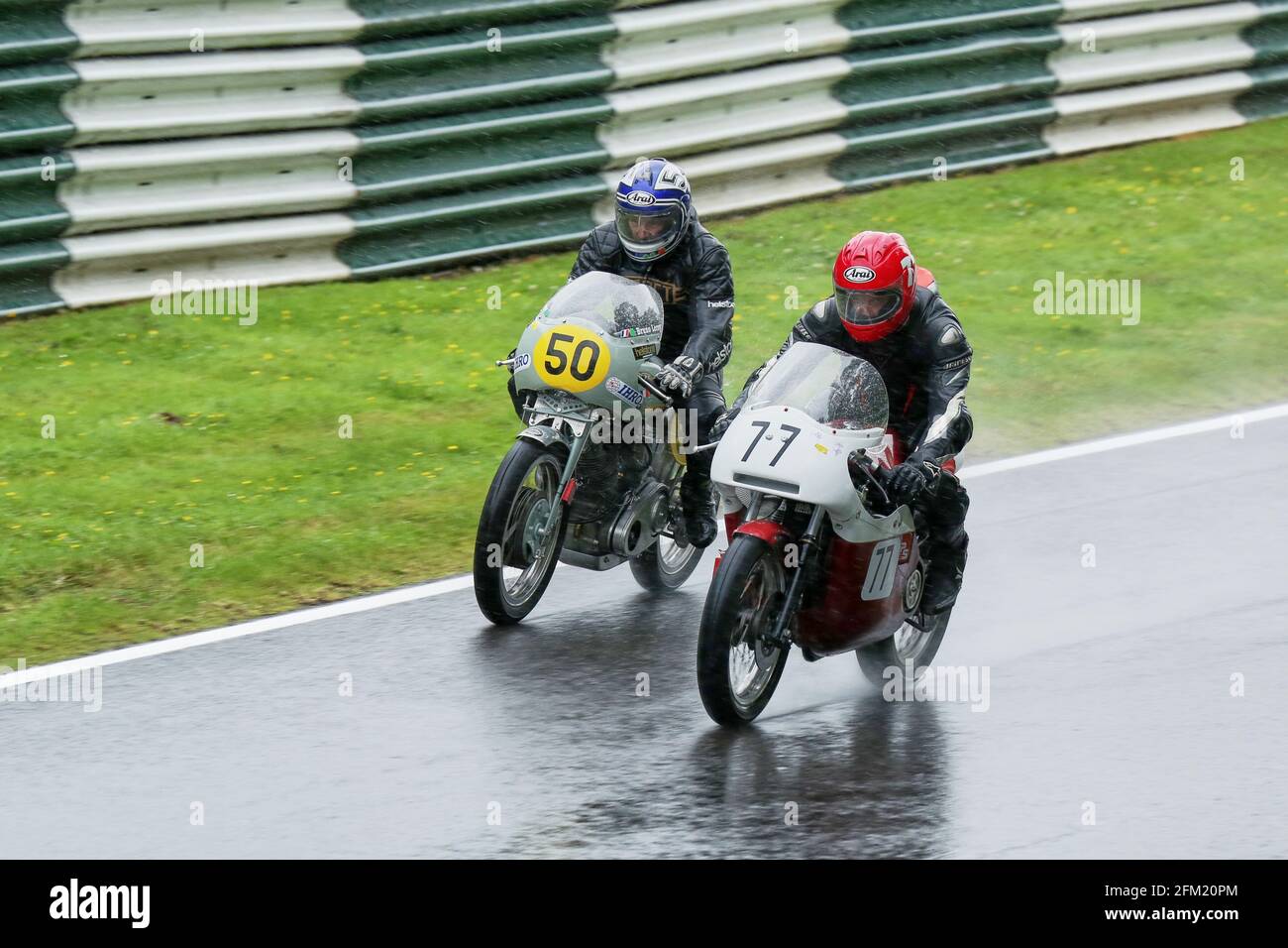 Gary Thwaites and Leroy Bruno racing side by side in the rain during the Classic King of Cadwell Race, the Cadwell International Classic in July 2015 Stock Photo
