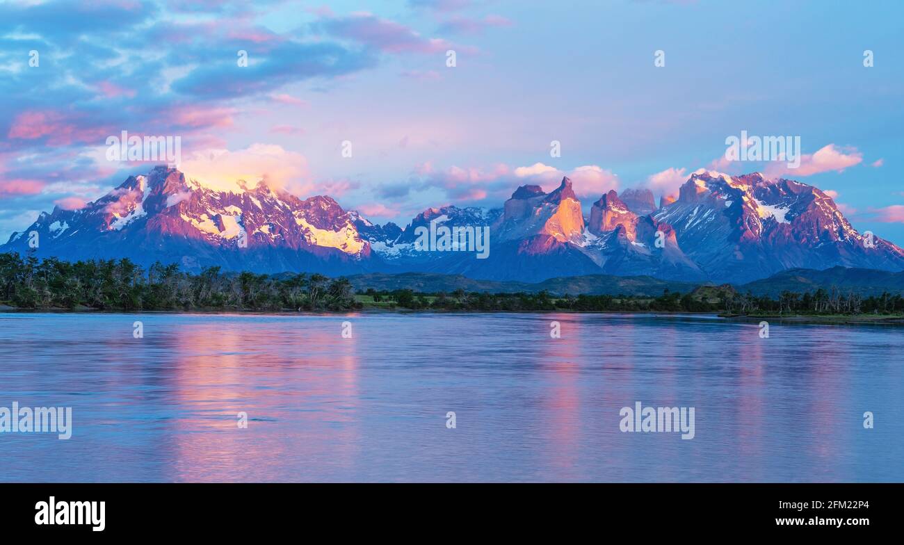 Panorama sunrise of the Serrano river with the Andes peaks of Torres del Paine, Patagonia, Chile. Stock Photo