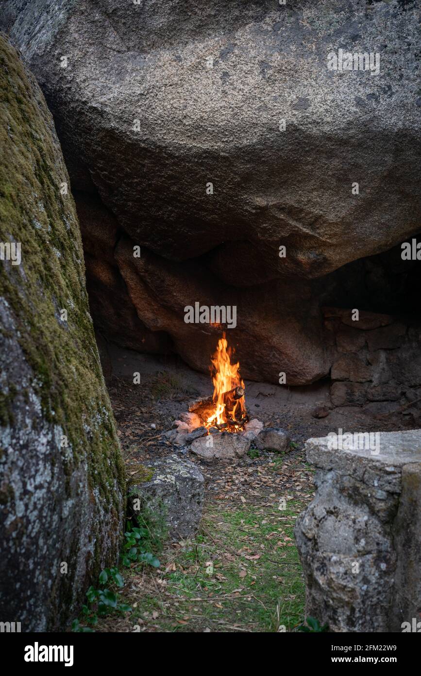Fire pit bonfire on the middle of boulders stones full with moss in ...
