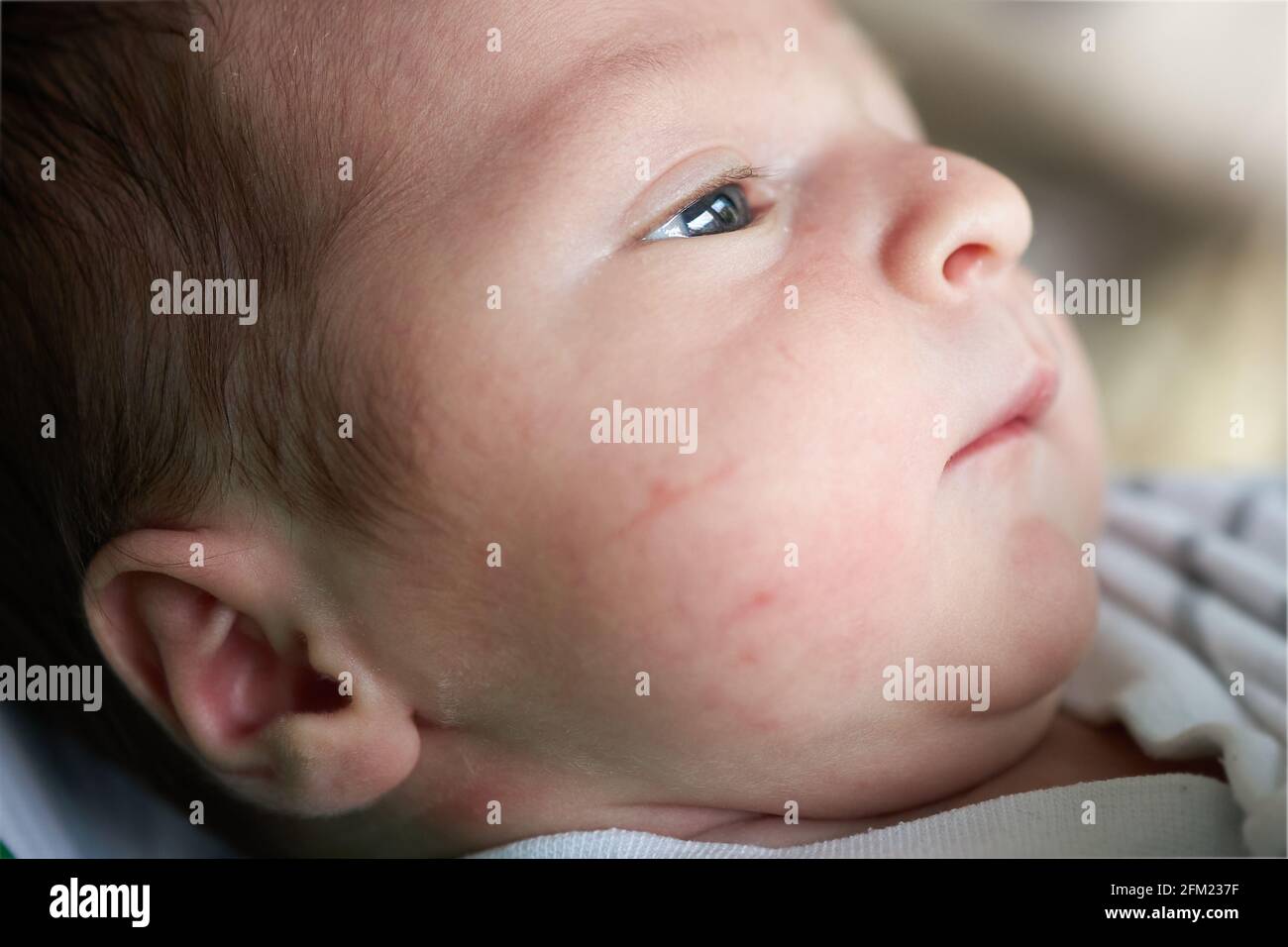 Beautiful newborn baby watching in the distance, hope concept Stock Photo