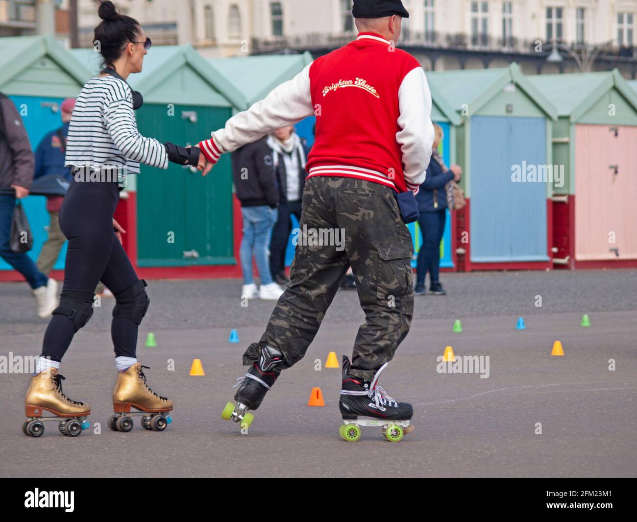 People rollerskating in Brighton hold hands Stock Photo Alamy