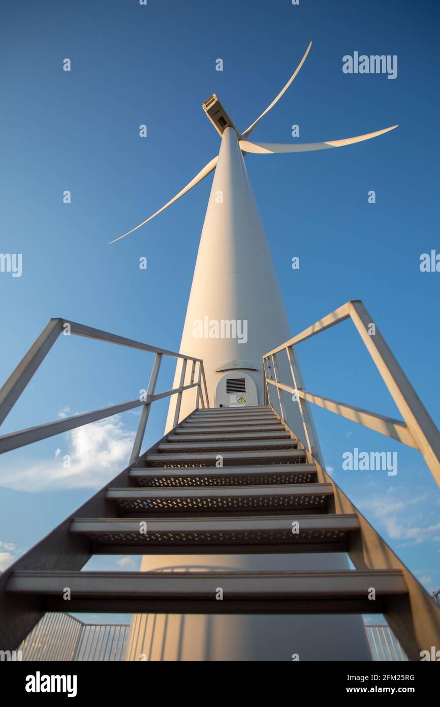 A wind turbine on the North Sea shore generating electricity Stock Photo