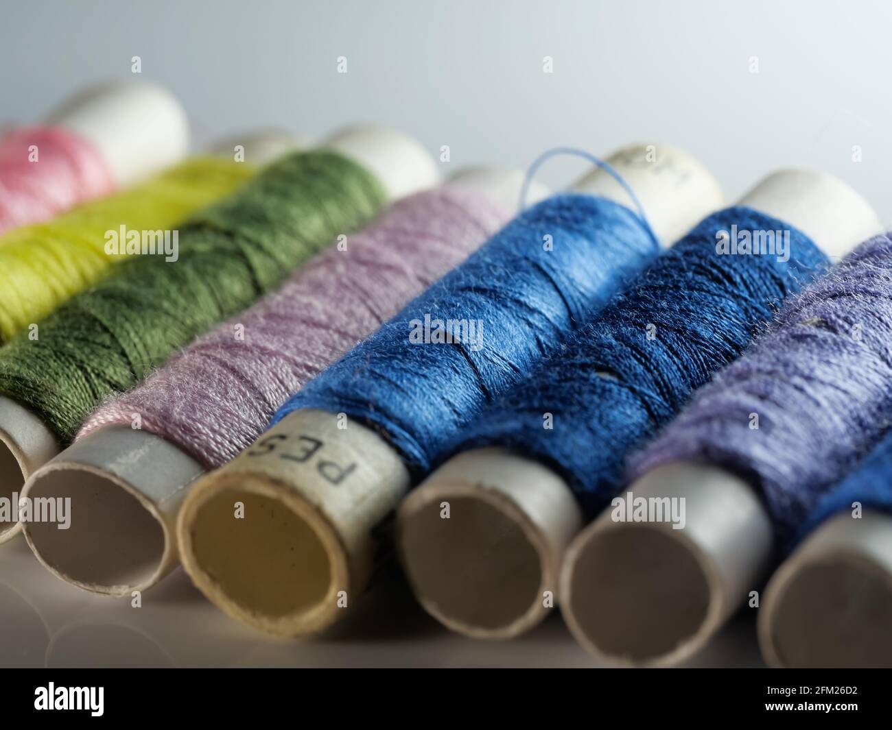 Sewing threads multicolored background closeup, selective focus, macro Stock Photo