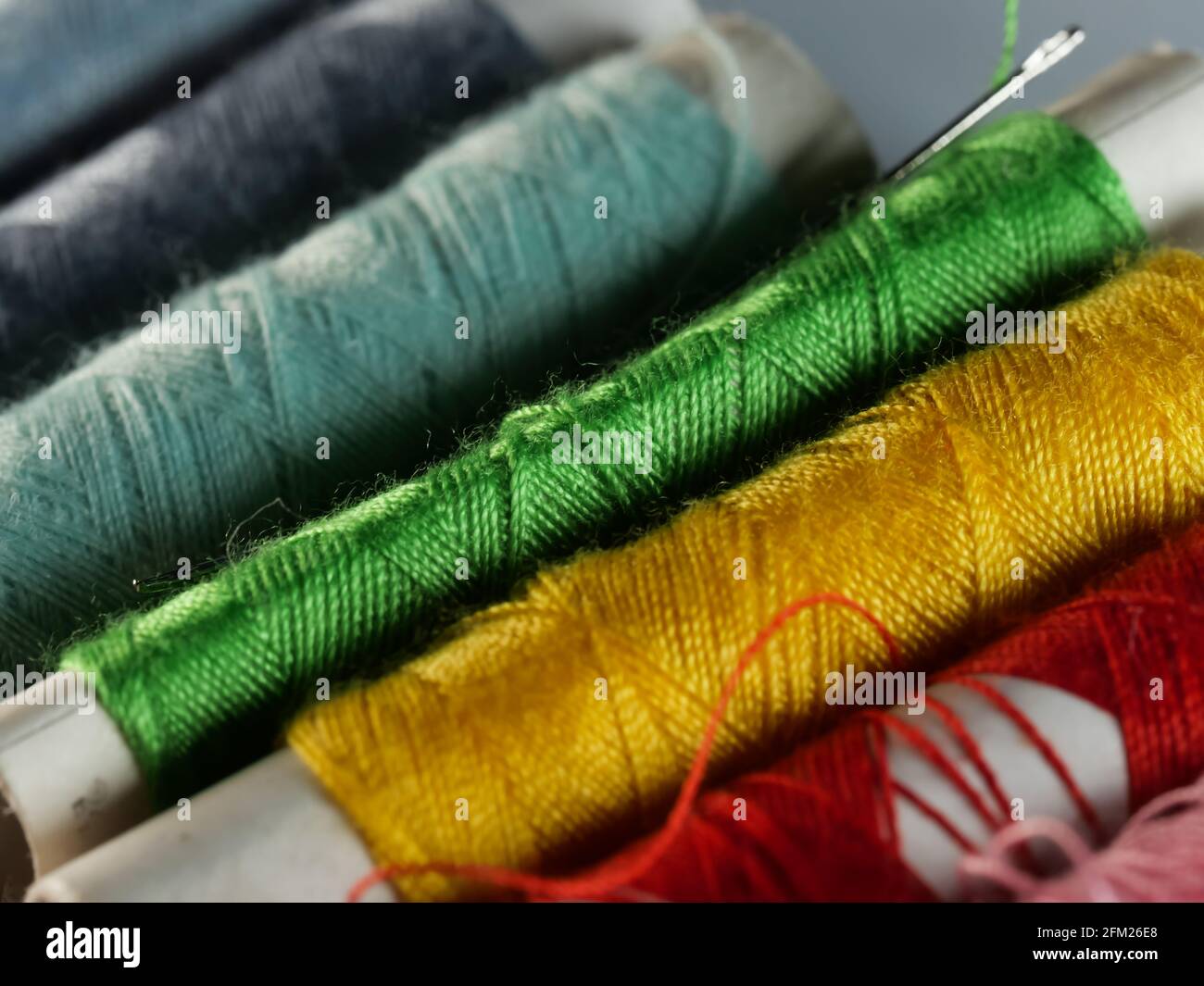 Sewing threads multicolored background closeup, selective focus, macro Stock Photo