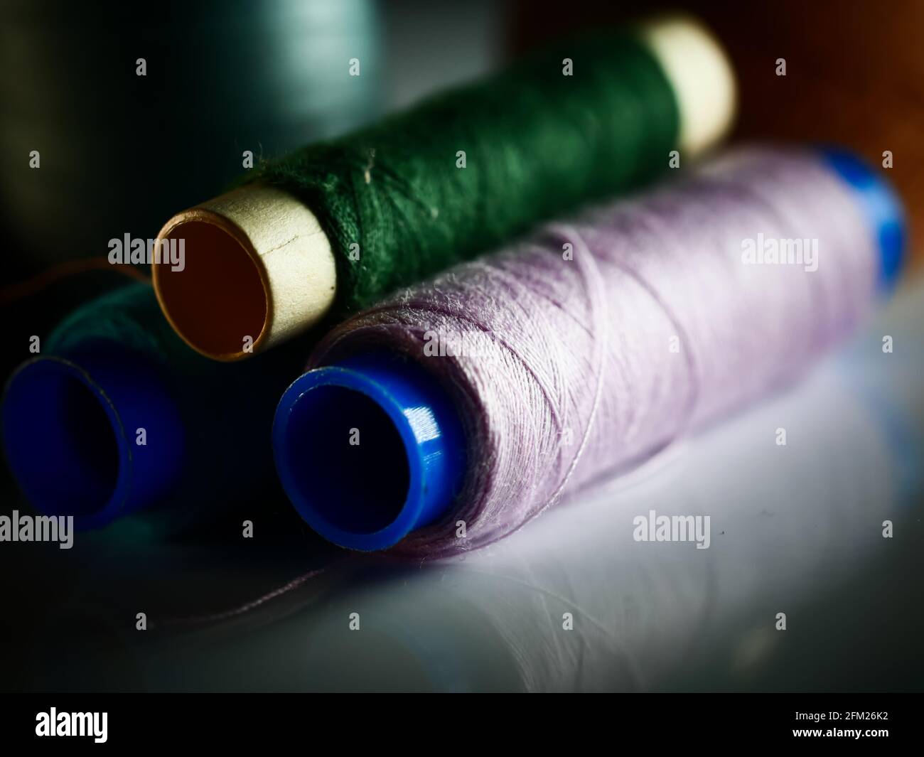 Sewing threads multicolored background closeup, selective focus, macro Stock Photo