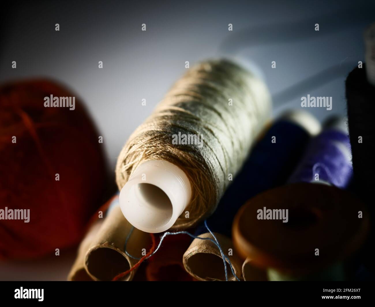 Sewing threads multicolored background closeup, selective focus, macro Stock Photo