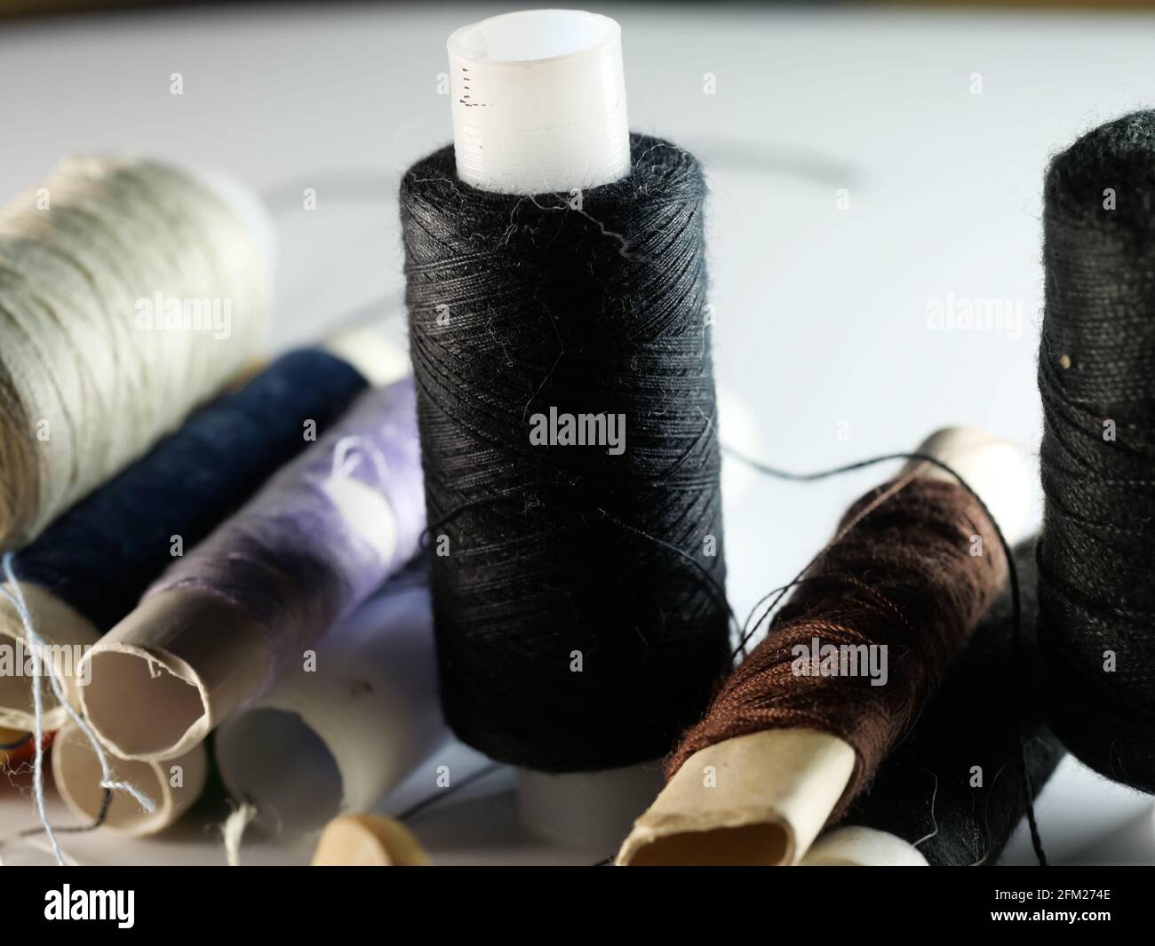 Sewing threads multicolored background closeup, selective focus, macro Stock Photo