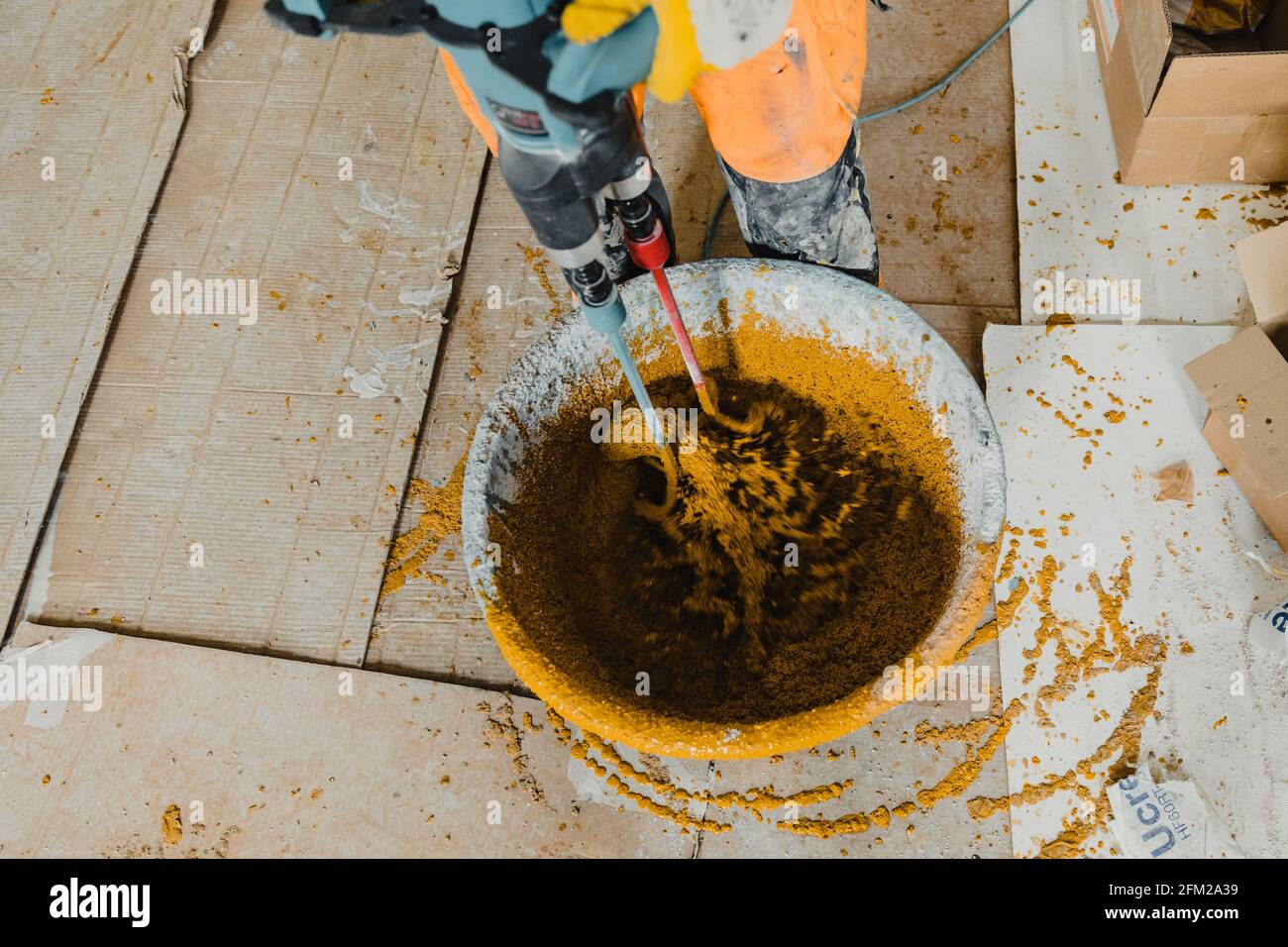 Photo in motion with a worker mixing colored polyurethane mortar with epoxy  resin Stock Photo - Alamy