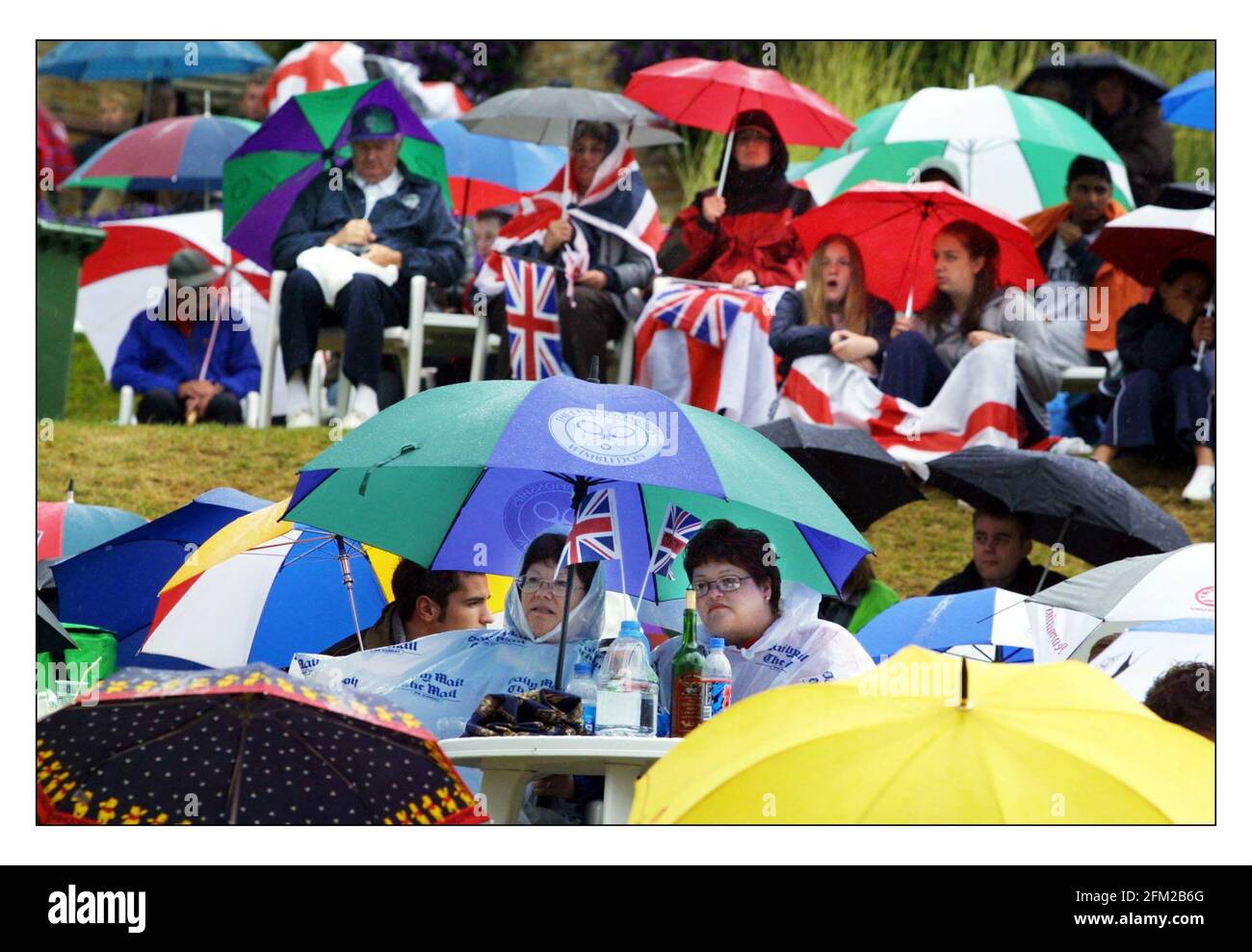 The rain in Wimbledon continues to fall.......and the fans sit and wait.pic David Sandison 3/7/2002 Stock Photo