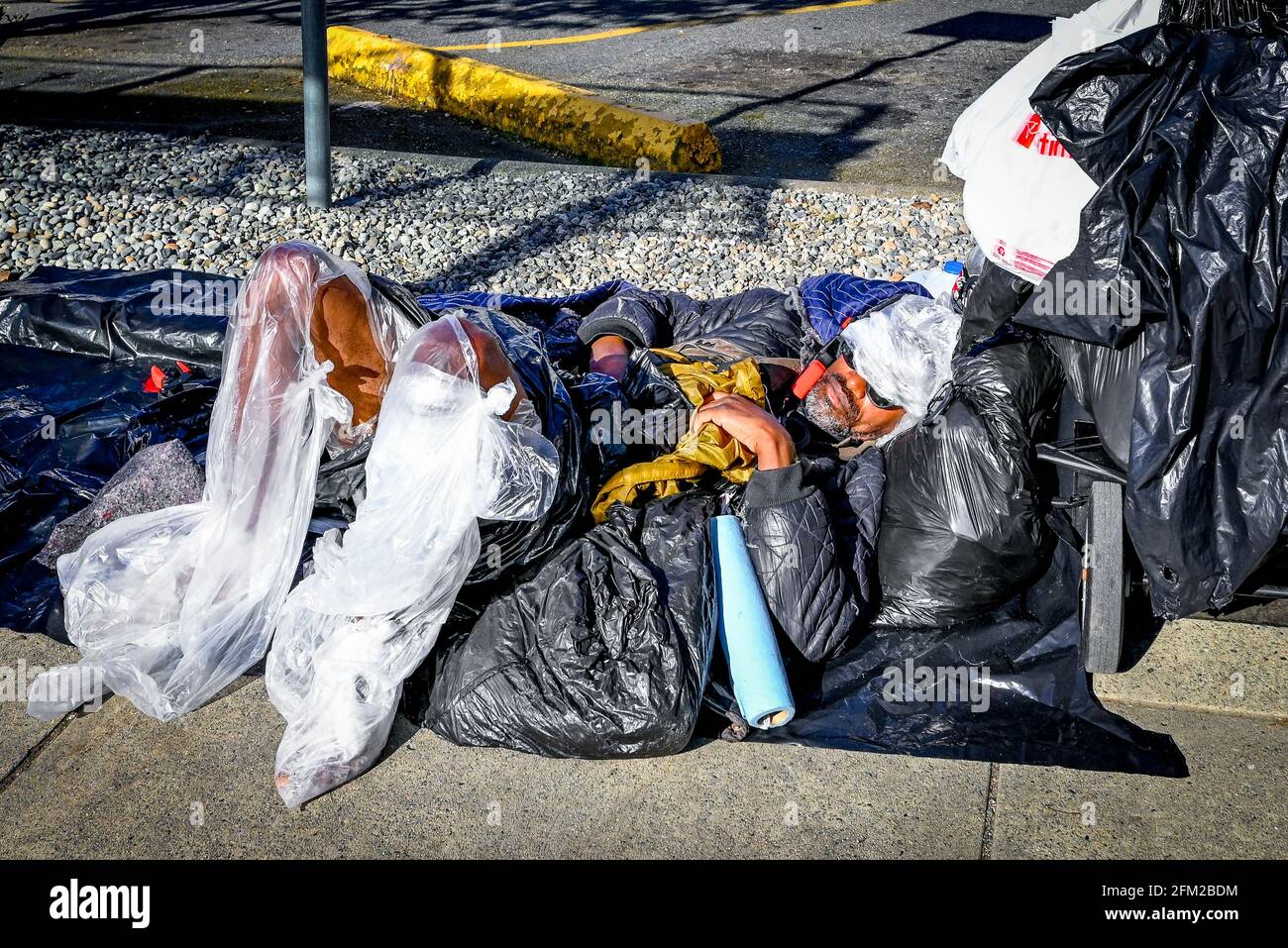 Homeless man wrapped in plastic hi-res stock photography and 