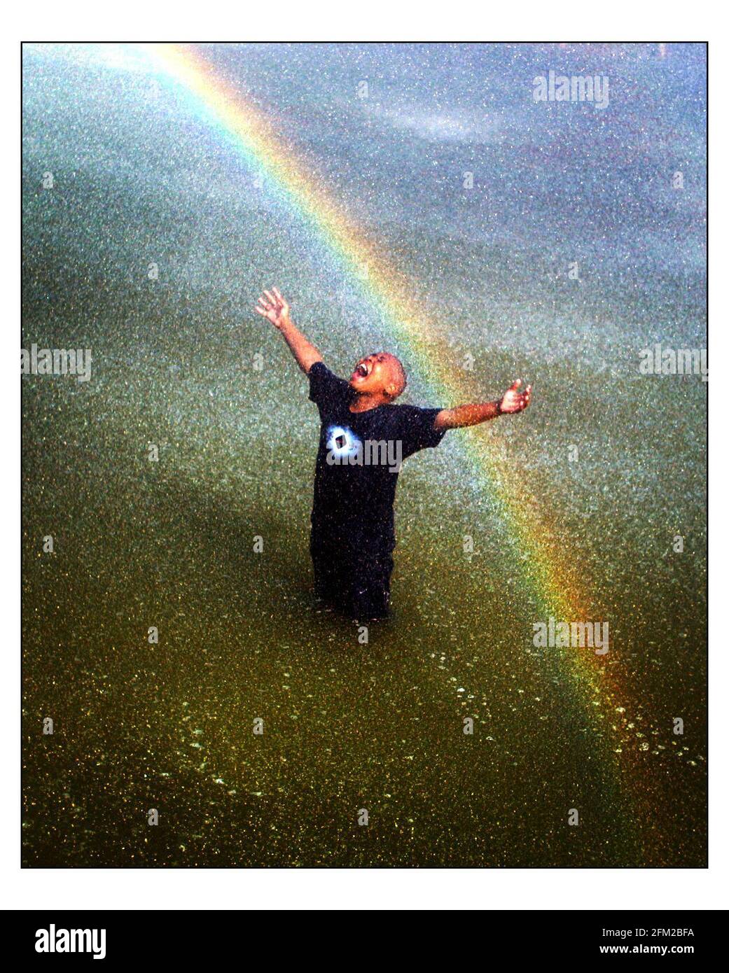 In the HEAT of the day.....Troy McDowell enjoyes a dip in the fountains in Battersea Park.....pic David sandison 29/5/2003 Stock Photo