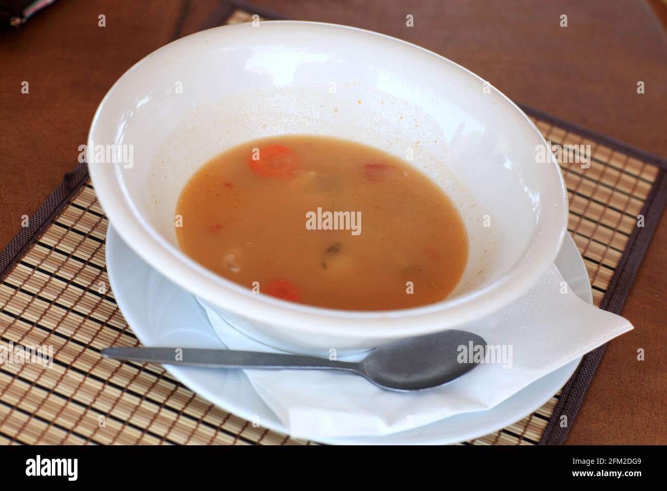 White plate with fish soup in a restaurant Stock Photo