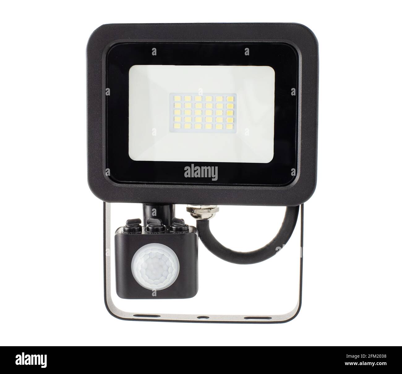 Motion sensor LED floodlight in hand on white background isolation. Stock Photo