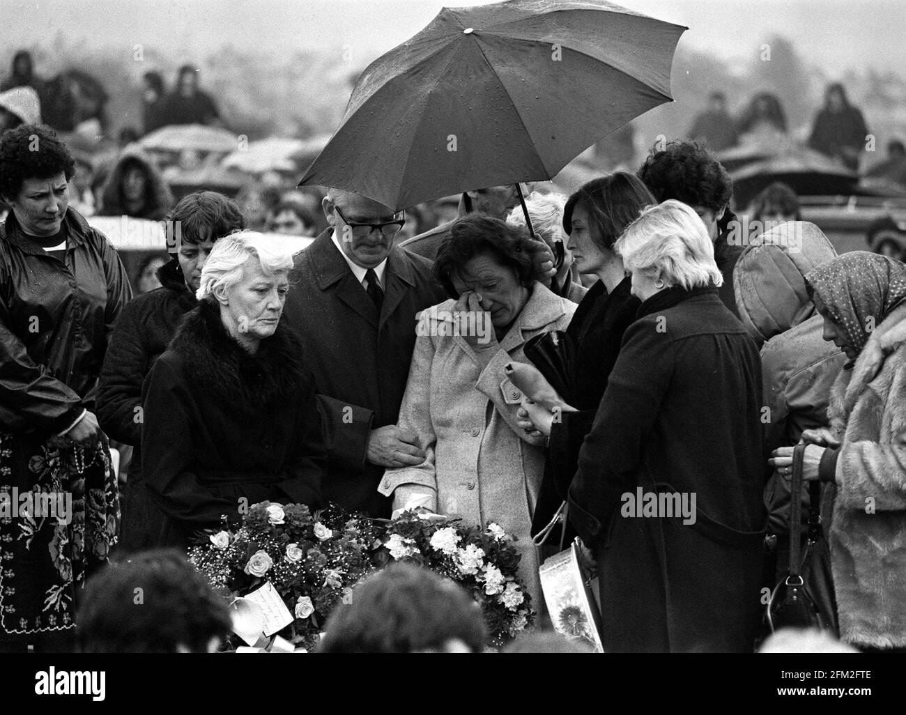 File photo dated 07/05/1981 of Bobby Sands mother Rosaleen, her husband John at the graveside during his funeral at Milltown cemetery in Belfast. The death of IRA prisoner Bobby Sands 40 years ago this week, followed by nine other republicans during a hunger strike at the Maze Prison in Co Antrim, sparked significant civil unrest across Northern Ireland. Issue date: Wednesday May 5, 2021. Stock Photo