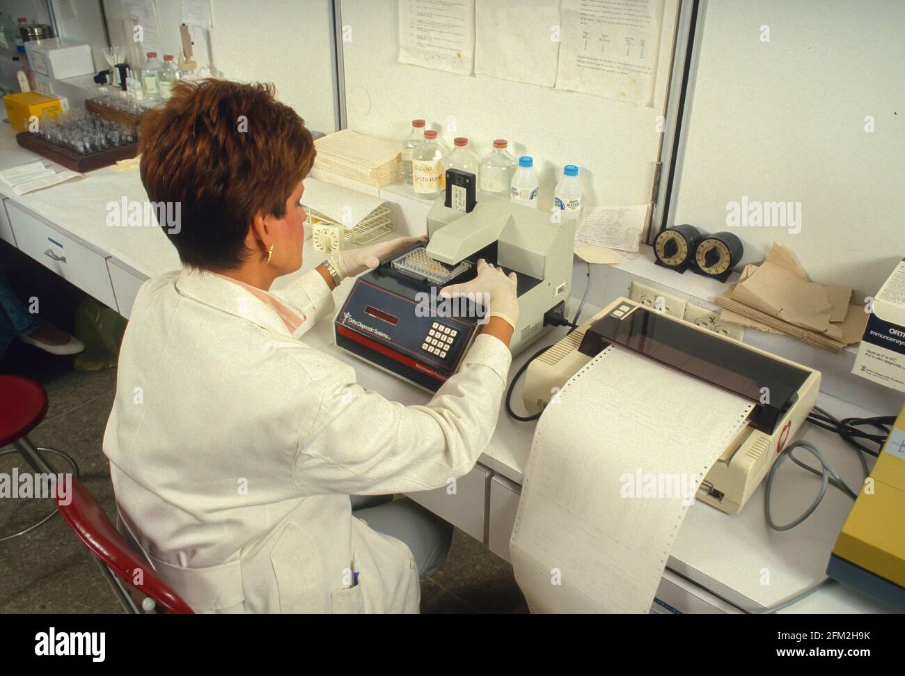 CARACAS, VENEZUELA, 1988 - Medical lab technician, Elisa AIDS test equipment. Stock Photo