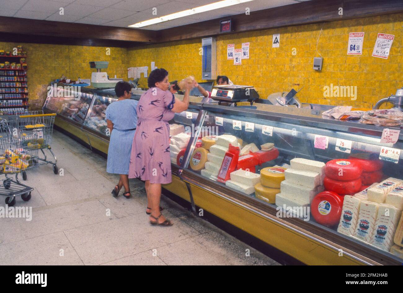 CARACAS, VENEZUELA, FEBRUARY 1988 - Women at cheese display, shopping in food store. Stock Photo