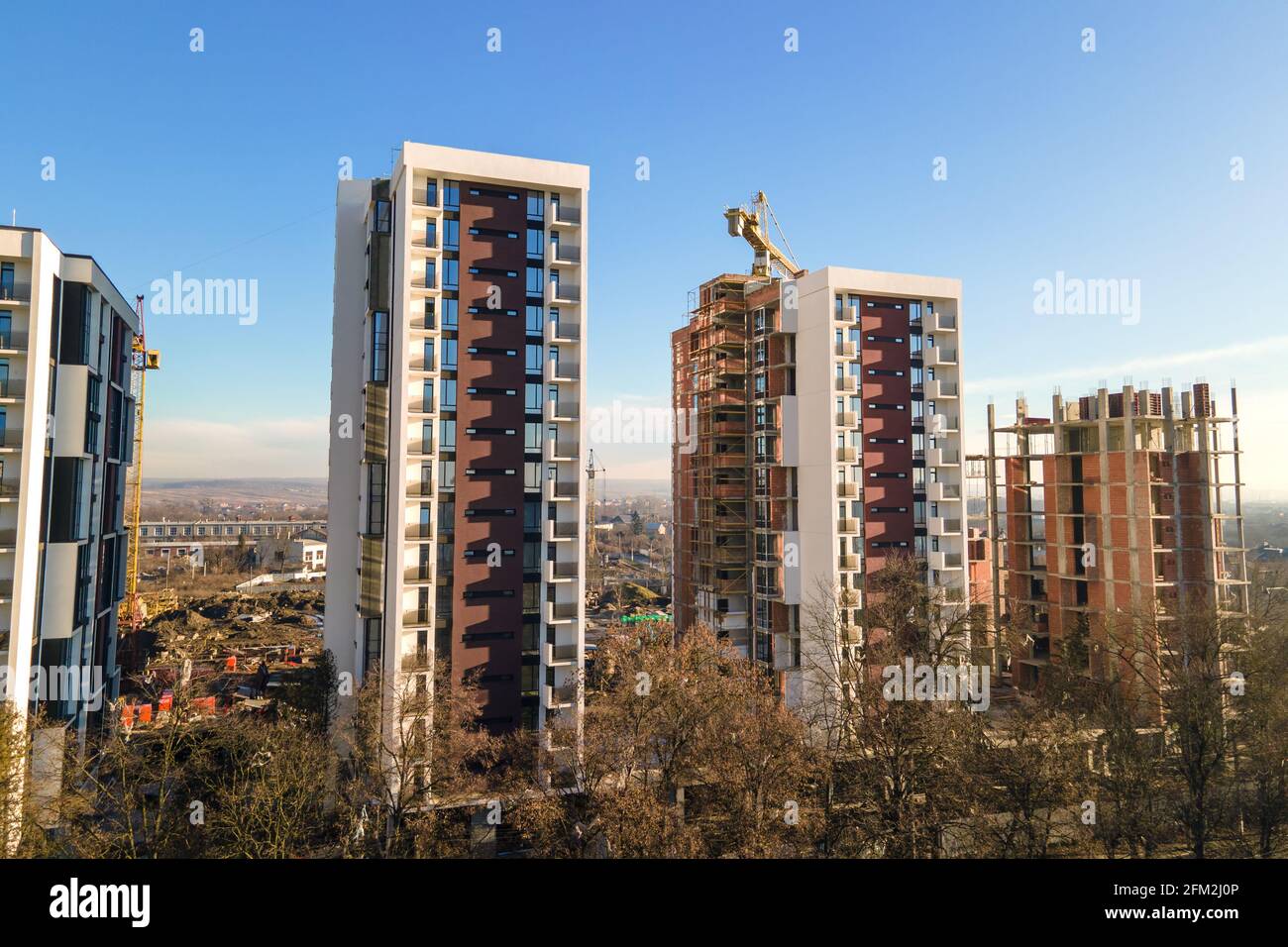 Aerial view of high tower crane and residential apartment buildings ...
