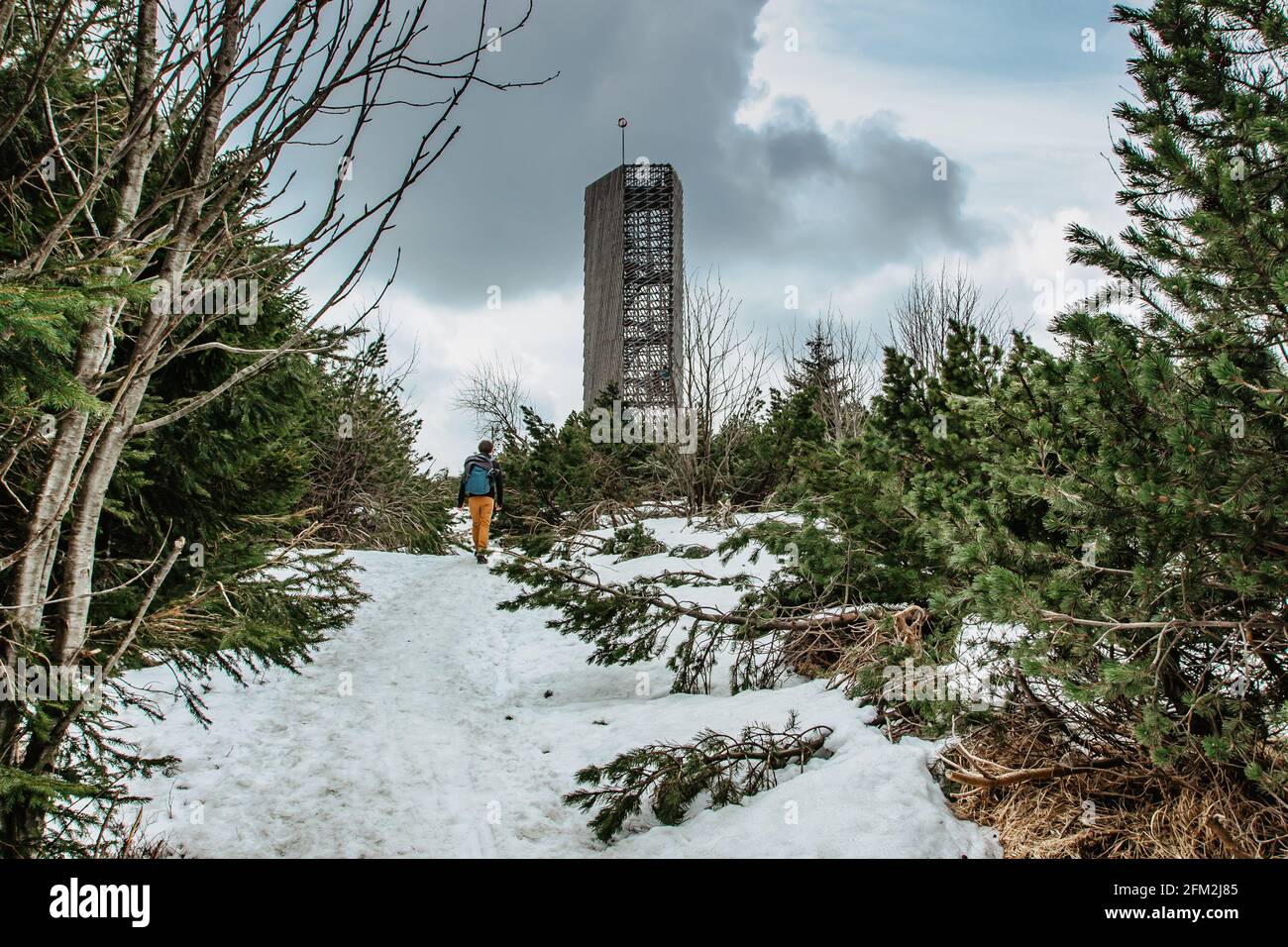 Backpacker walking to Velka Destna Lookout Tower,Orlicke,Eagle, Mountains,Czech republic.Enjoy freedom of winter hiking,active lifestyle and landscape Stock Photo