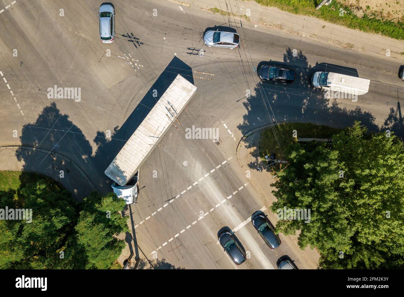 Top down aerial view of busy street intersection with moving cars ...