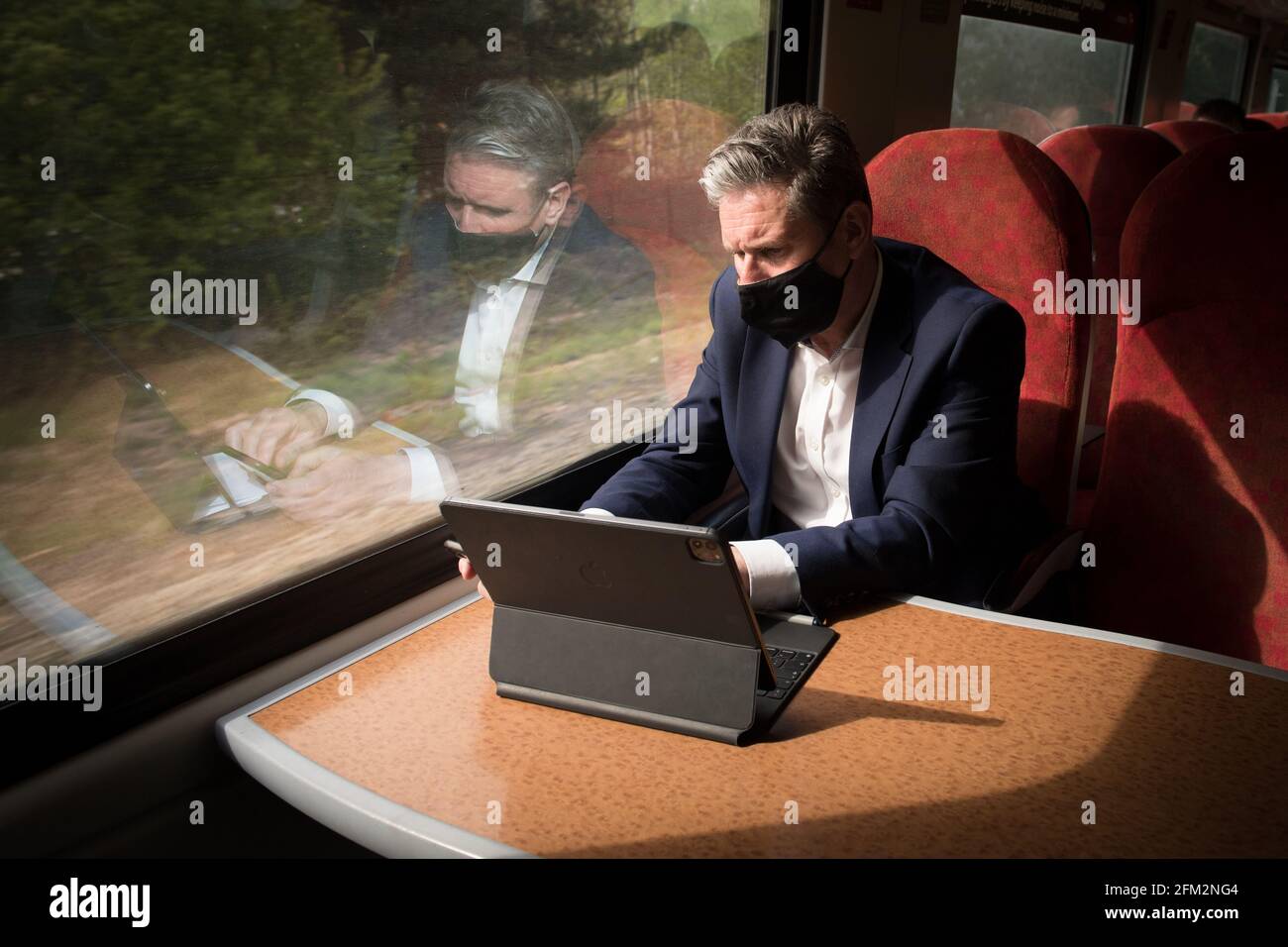 Leader of the Labour Party Sir Keir Starmer works on a train as he travels to canvass voters in Keynsham, Somerset, whilst on the election campaign trail for West of England Mayor Dan Norris. Picture date: Wednesday May 5, 2021. Stock Photo