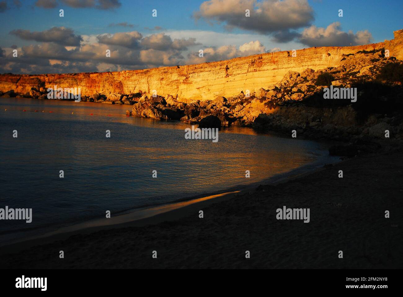 Golden sunset on the Paradise beach in Malta Stock Photo
