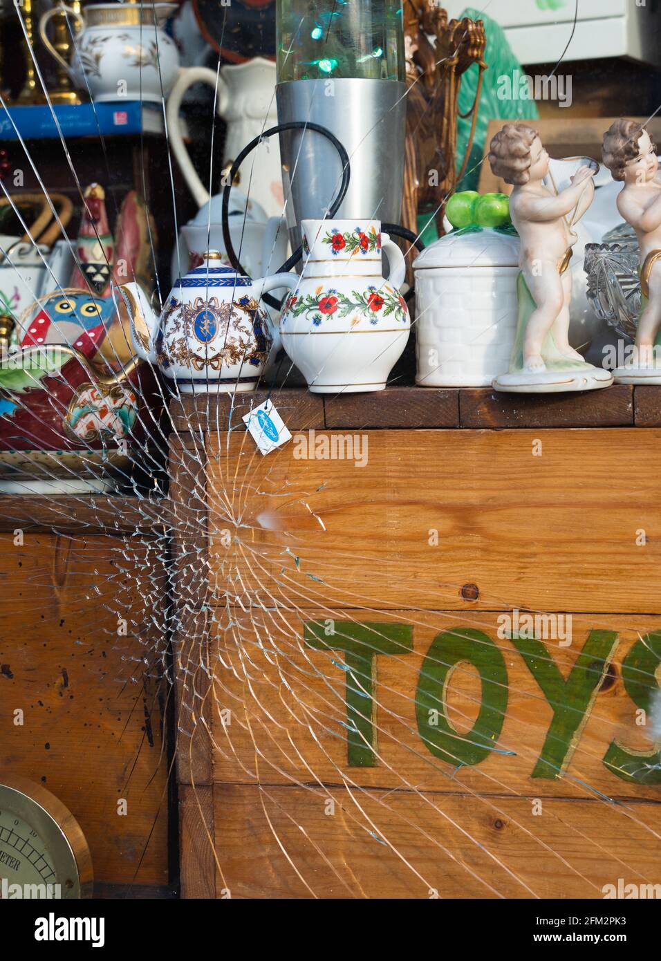 Broken, shop window, safety glass, laminated, shatter proof, smash and grab, toys, antiques, collectables, knickknacks, toys, ornaments, tea pot. Stock Photo