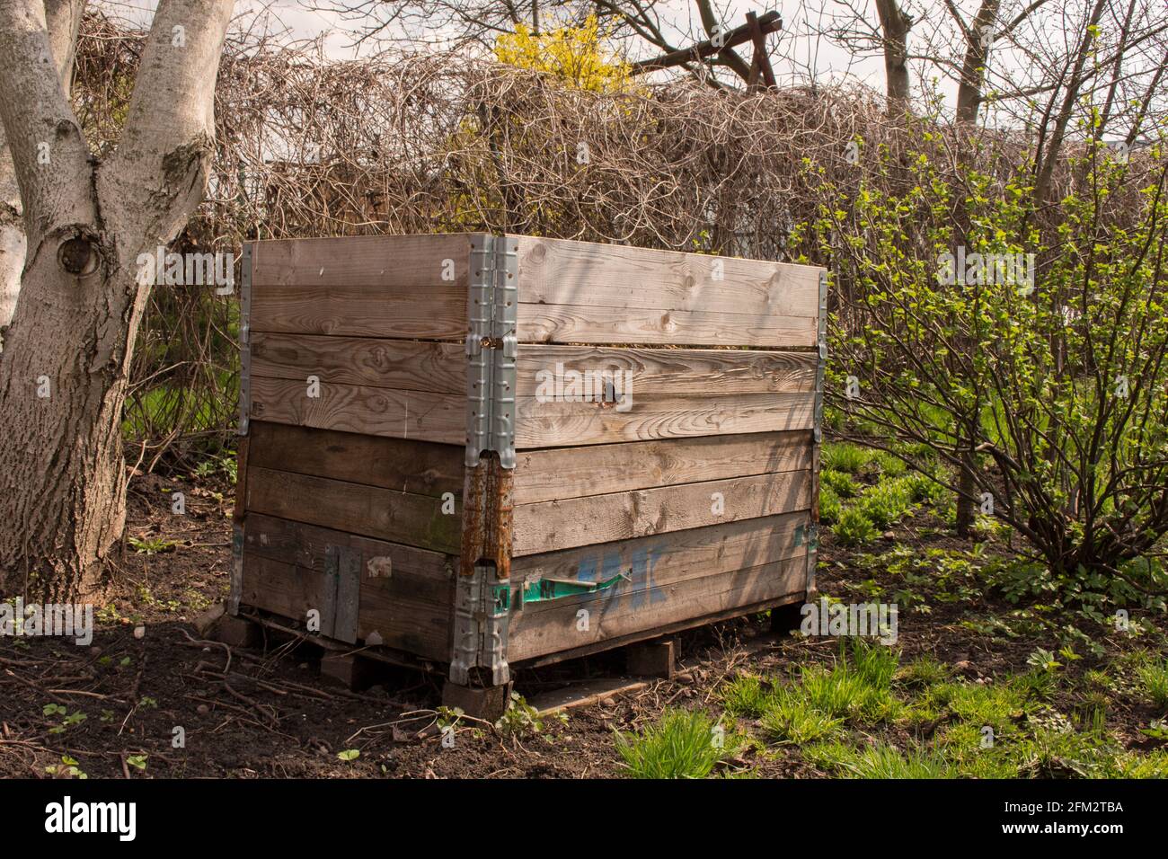 Compost bin in the garden. Composting a pile of rotting kitchen fruit