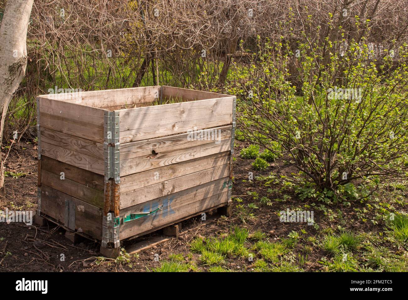 Compost bin in the garden. Composting a pile of rotting kitchen fruit