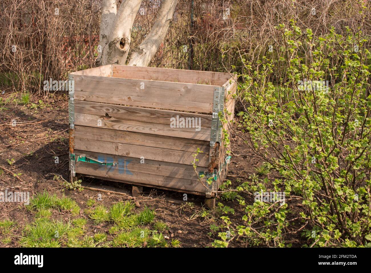 Compost bin in the garden. Composting a pile of rotting kitchen fruit