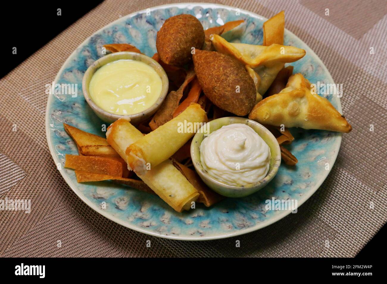 lebanese arabic food speciality deep fried hot mezze selection includes spinach fatayer, cheese rolls and lamd kebbe, meddle eastern food Stock Photo