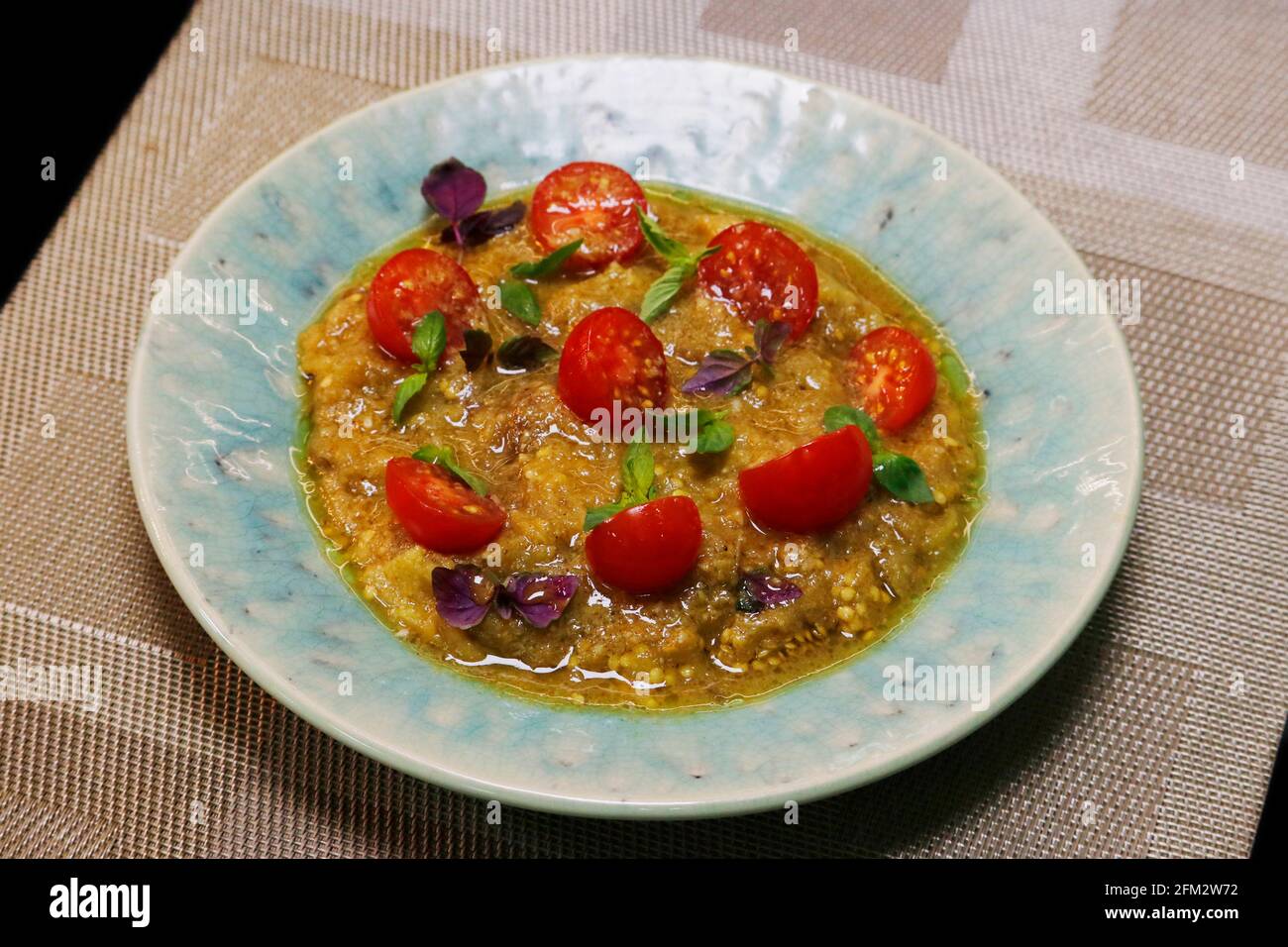 smoked aubergine or eggplant and cherry tomato salad, middle eastern food Stock Photo