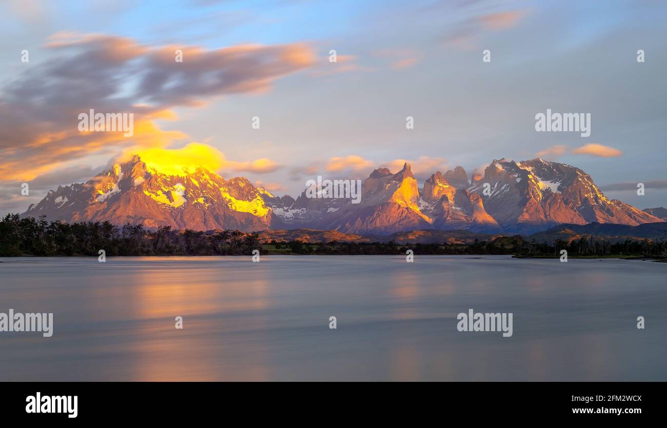 Serrano river sunrise panorama with Torres del Paine and Cuernos del Paine mountain peaks, Torres del Paine national park, Patagonia, Chile. Stock Photo