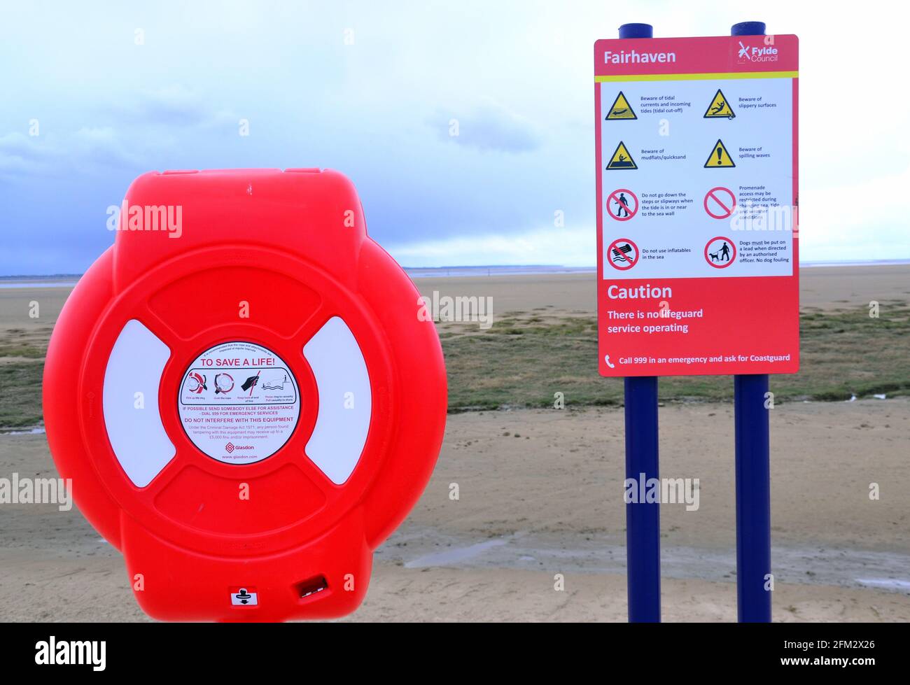 Glasdon life ring or lifebuoy and safety warning sign beside the beach at St Annes On Sea, Fylde, Lancashire, England, United Kingdom Stock Photo