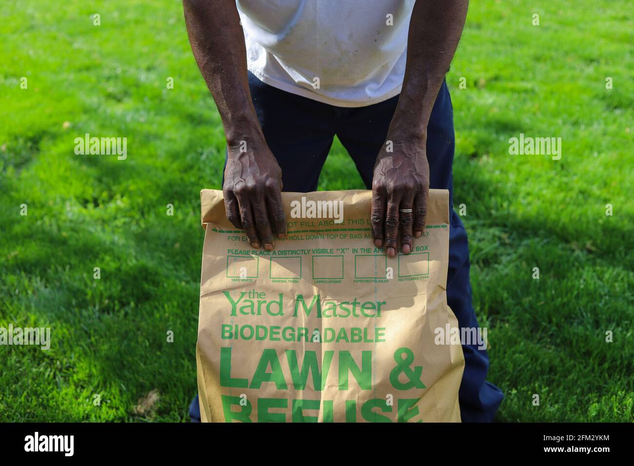 Louisville, Ky USA- May 3, 2021: A black man holding a Yard Master biodegradable Lawn and Refuse bag Stock Photo