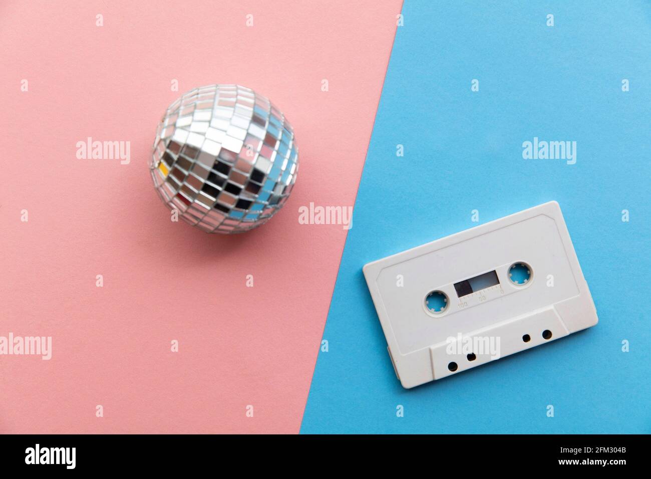 Retro disco glitter ball with a vintage cassette tape Stock Photo