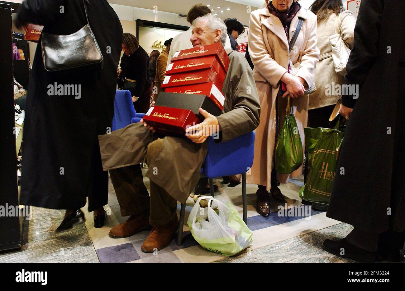 Harrods Winter Sales January 2002A GENT GETS LUMBERED GUARDING HIS WIFE