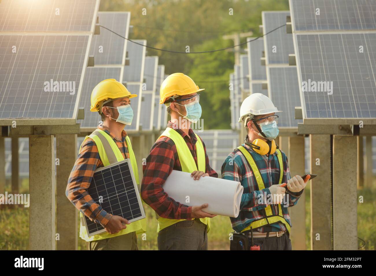 Three engineers working at a solar powered station, Thailand Stock ...