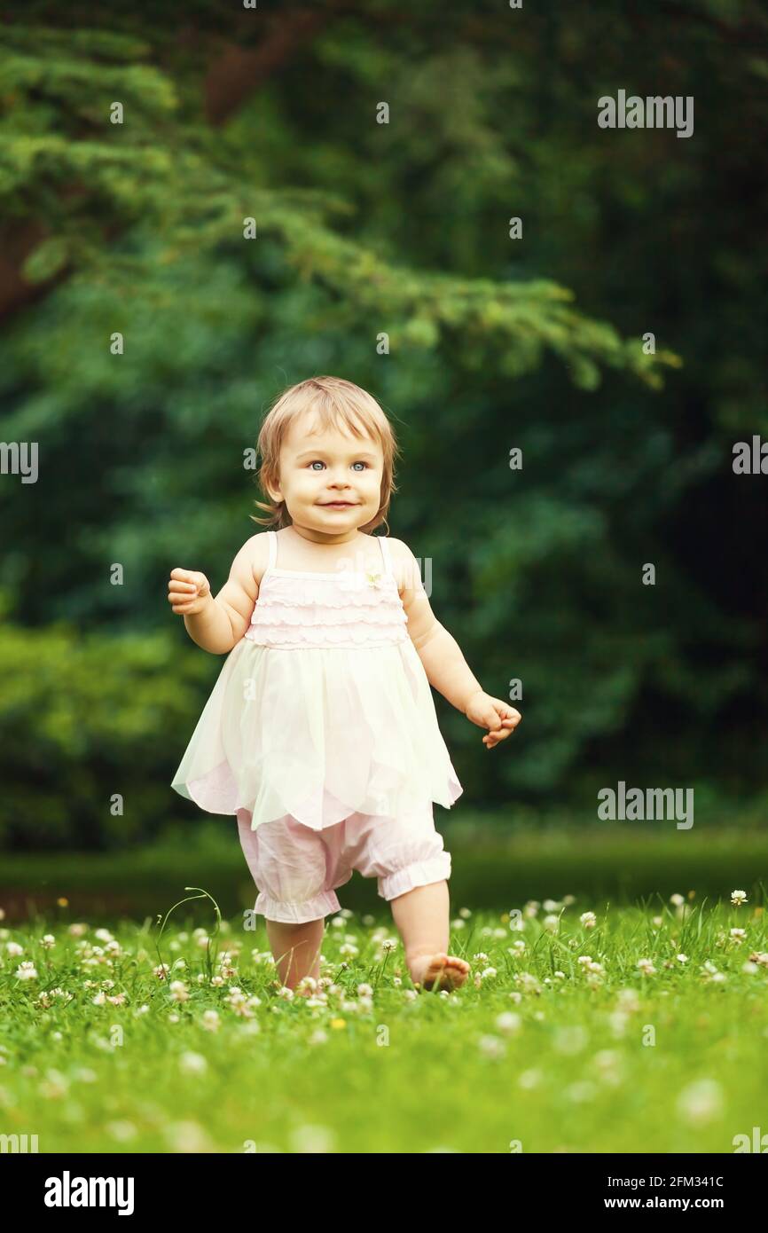 Little girl walking in the park Stock Photo - Alamy
