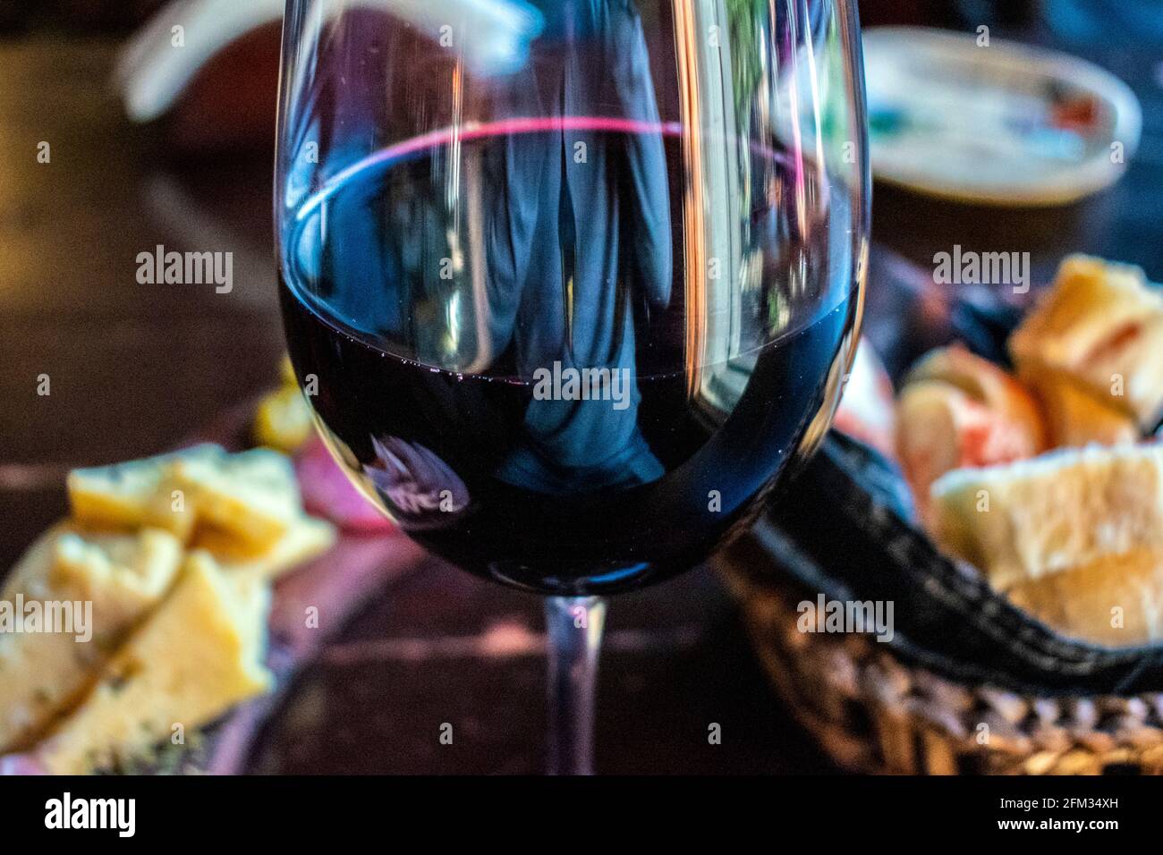 Glass of red wine with cold cuts and cheeses ("picada Stock Photo Alamy