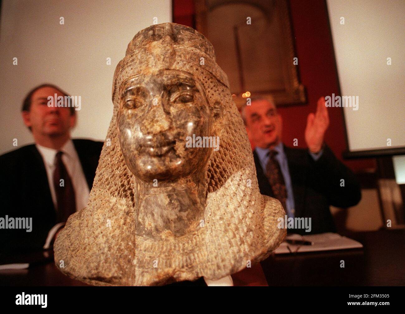 The sculpted head of an Egyptian queen January 2000(thought to be Nefertari) - the so-called Head of Meryet, which was smuggled out of Egypt in the early 1990's, was today returned to the Egyptian government by handing it over to the Egyptian ambassador Mr Adel El-Gazzar, by Dr Robert Anderson, the director of the British Museum. The picture shows Left; Dr Anderson and right;Mr El-Gazzar, with the head at the British Museum. Stock Photo